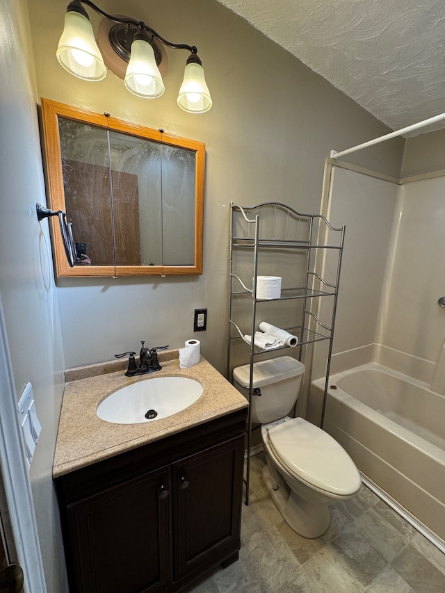 full bath with a textured ceiling, vanity, toilet, and shower / bathtub combination