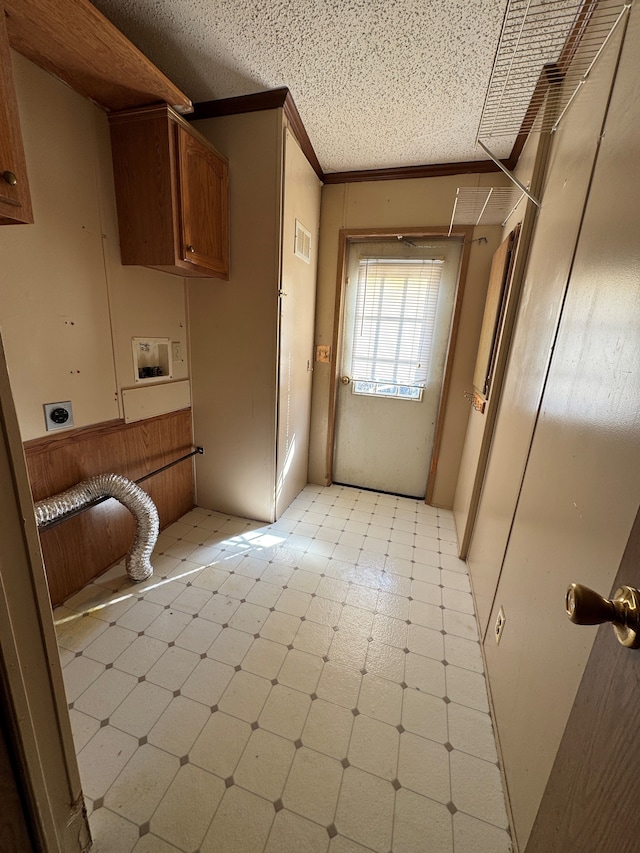 interior space with light floors, cabinet space, ornamental molding, hookup for an electric dryer, and a textured ceiling