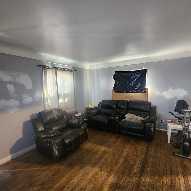 living room featuring hardwood / wood-style flooring and baseboards