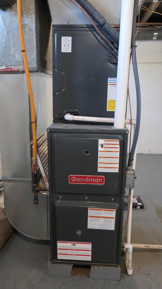 utility room featuring heating unit