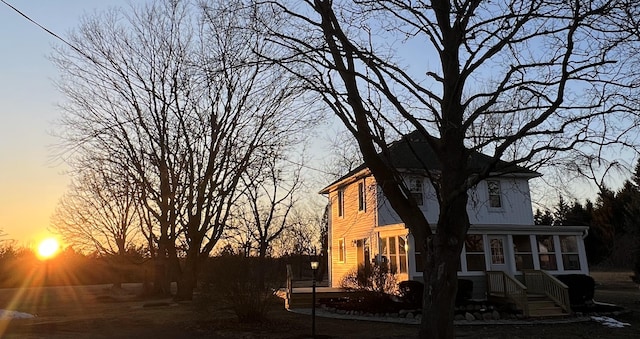 view of side of property featuring a sunroom