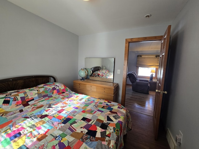 bedroom featuring visible vents and dark wood finished floors