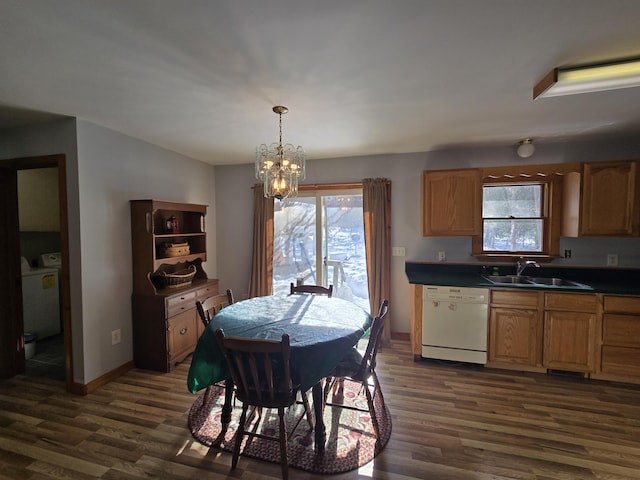 dining room featuring washer / clothes dryer, dark wood finished floors, and a wealth of natural light