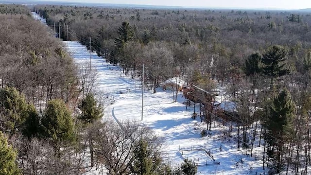 snowy aerial view with a forest view