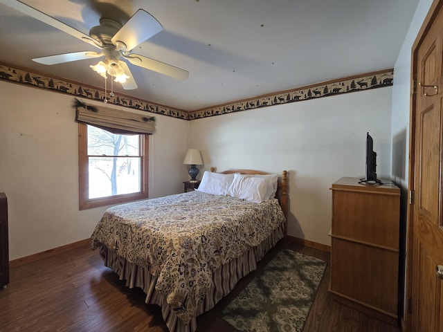 bedroom with ceiling fan, baseboards, and dark wood finished floors