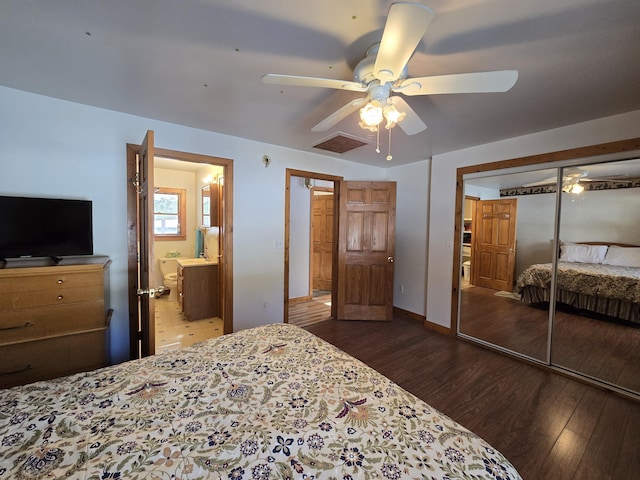 bedroom featuring a closet, visible vents, ensuite bathroom, dark wood-type flooring, and a ceiling fan