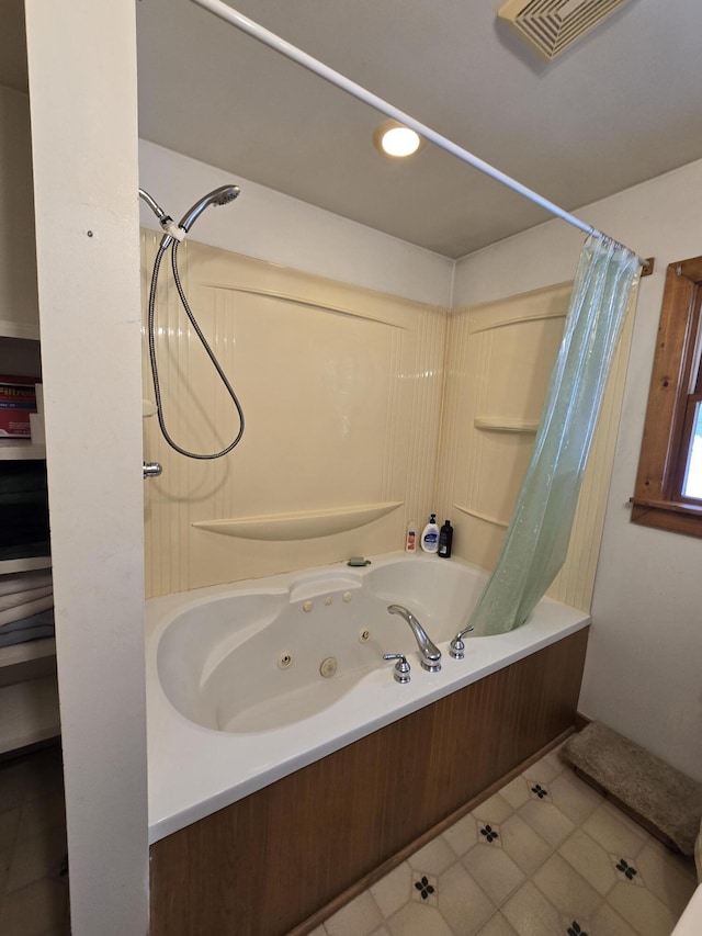 bathroom with a combined bath / shower with jetted tub and visible vents