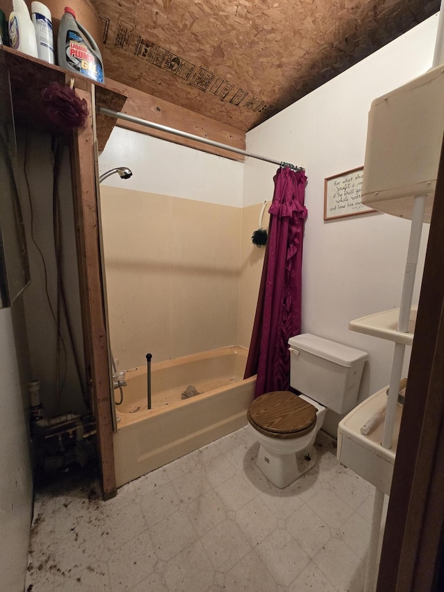 bathroom featuring shower / tub combo with curtain, toilet, and tile patterned floors