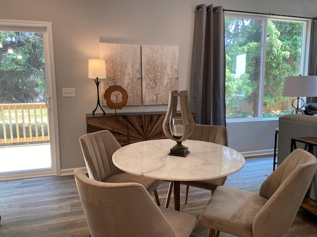 dining space featuring a wealth of natural light, baseboards, and wood finished floors