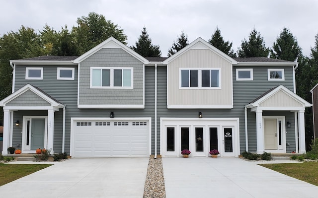 view of property with an attached garage and concrete driveway