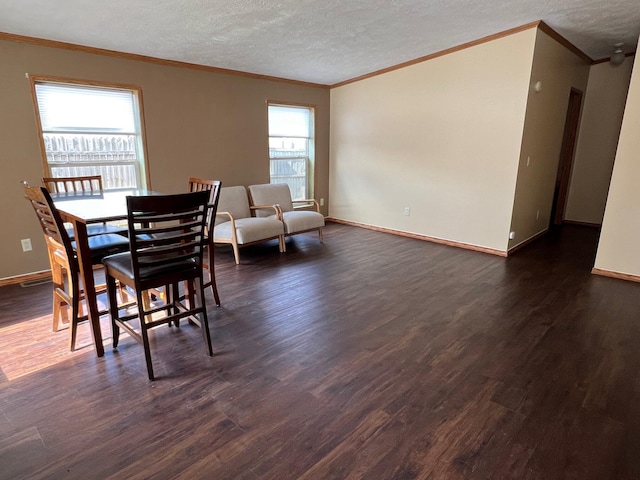 dining space featuring a textured ceiling, dark wood finished floors, and baseboards