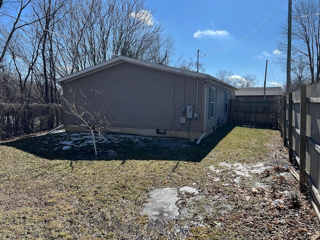 view of side of home with a fenced backyard