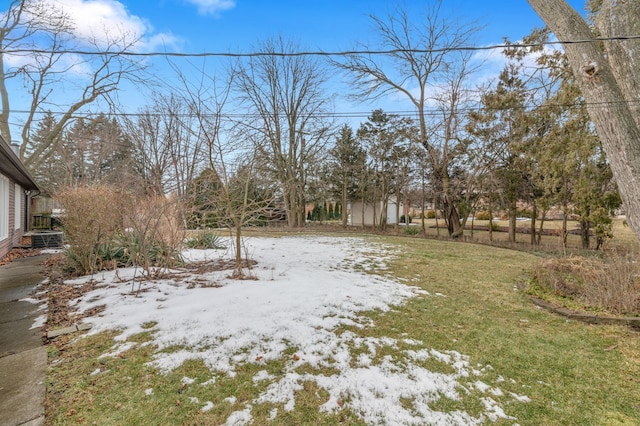 yard covered in snow featuring cooling unit and fence