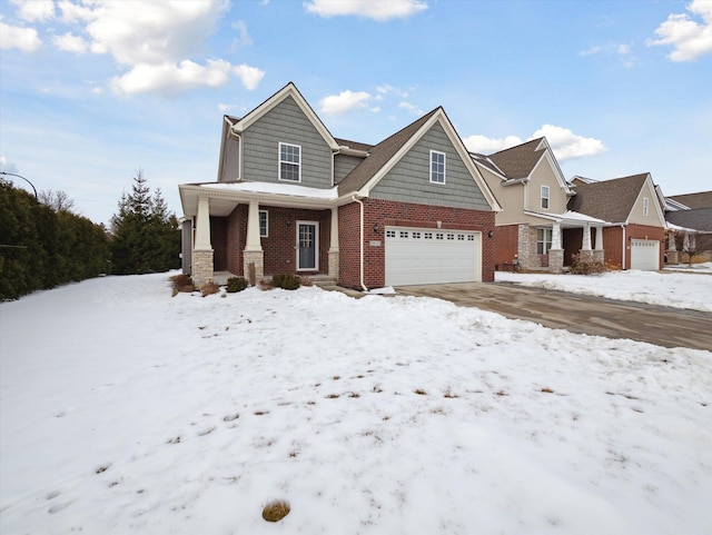 view of front facade featuring a garage, brick siding, and a porch