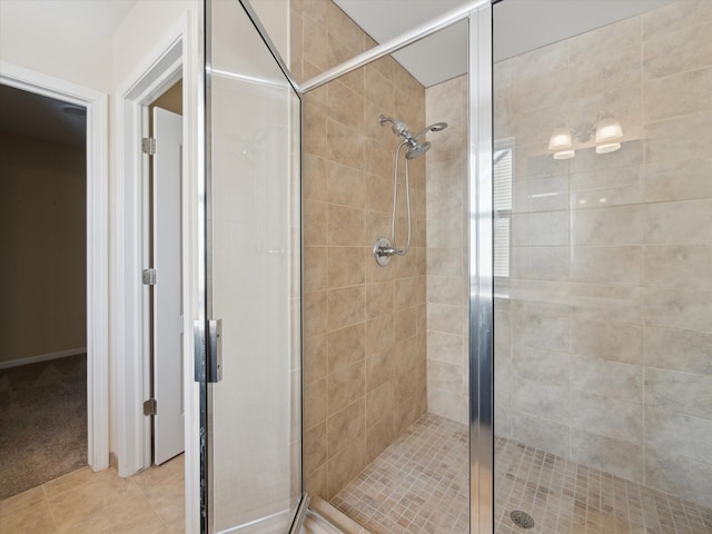 full bath with tile patterned flooring and a shower stall