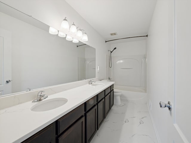 bathroom with double vanity, marble finish floor, a sink, and shower / bathing tub combination