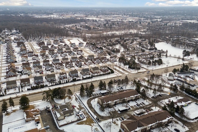 snowy aerial view featuring a residential view