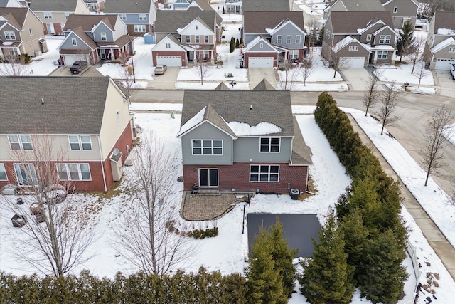 snowy aerial view featuring a residential view