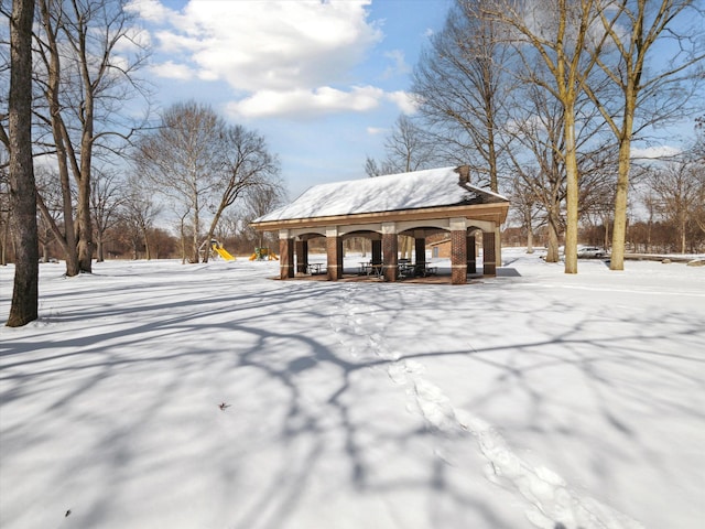 exterior space featuring brick siding and a gazebo