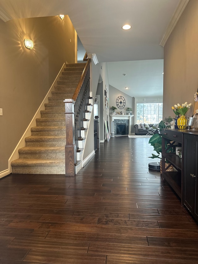 entryway with recessed lighting, a fireplace, baseboards, stairway, and dark wood-style floors