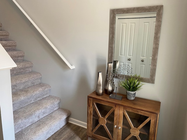 stairs with baseboards and wood finished floors