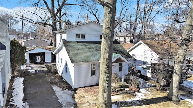 exterior space with roof with shingles