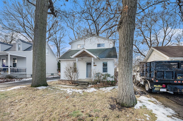 view of front of home featuring covered porch and roof with shingles