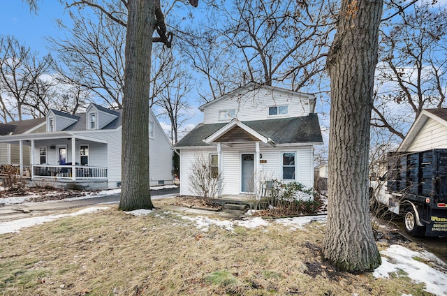 view of front of home featuring covered porch and roof with shingles