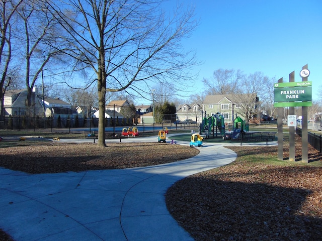 view of community featuring a residential view, playground community, and fence