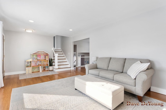 living area with stairs, baseboards, wood finished floors, and recessed lighting