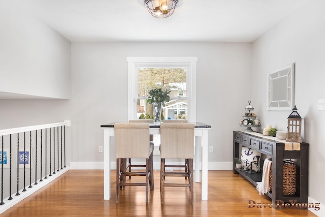 dining room featuring wood finished floors and baseboards