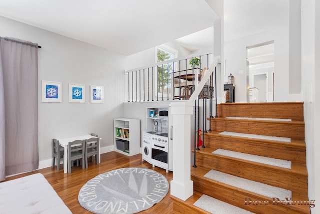 stairs featuring baseboards and wood finished floors