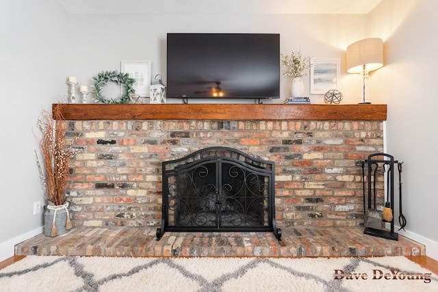 details featuring a fireplace and baseboards