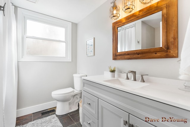 bathroom with baseboards, visible vents, toilet, tile patterned floors, and vanity