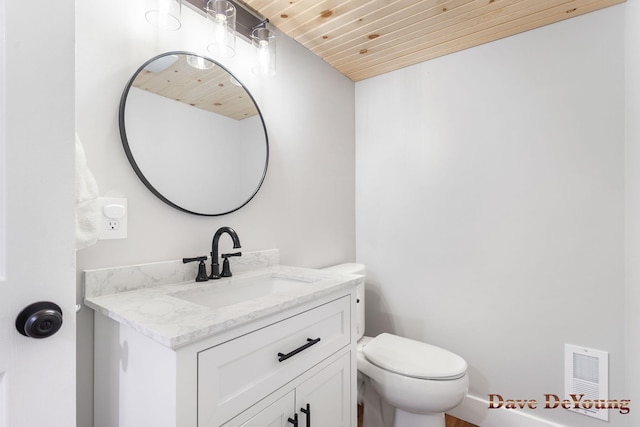 bathroom featuring toilet, wooden ceiling, vanity, and visible vents