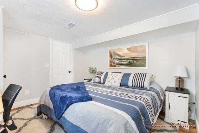 bedroom featuring baseboards and visible vents