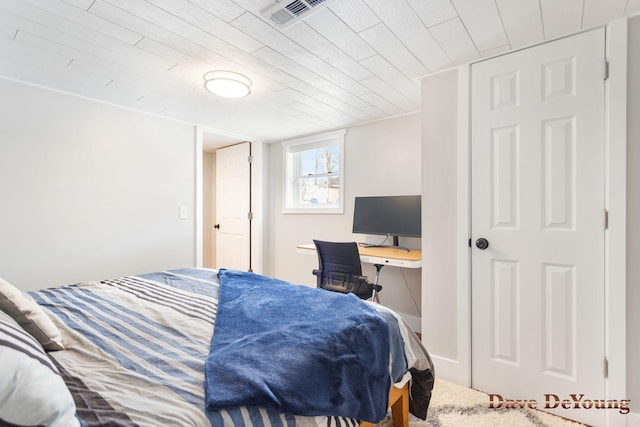 bedroom with wood ceiling and visible vents