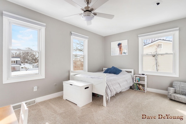 carpeted bedroom with ceiling fan, multiple windows, visible vents, and baseboards