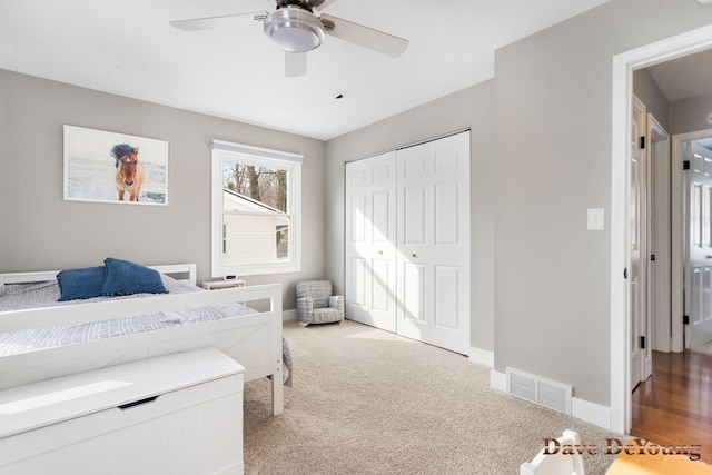 bedroom featuring a closet, visible vents, a ceiling fan, carpet flooring, and baseboards