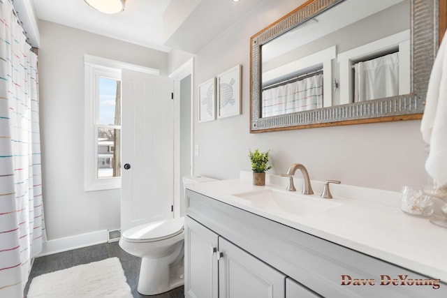 bathroom featuring toilet, baseboards, and vanity