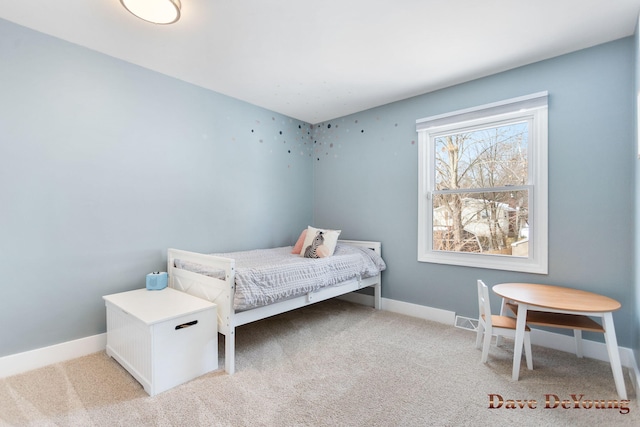 bedroom with light carpet and baseboards