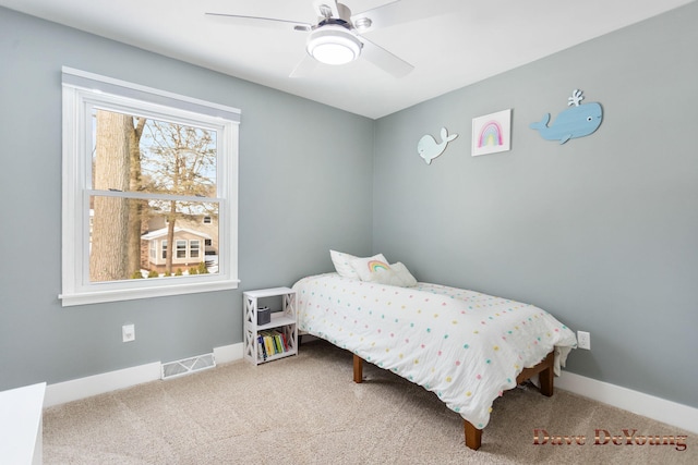 bedroom featuring carpet floors, a ceiling fan, visible vents, and baseboards