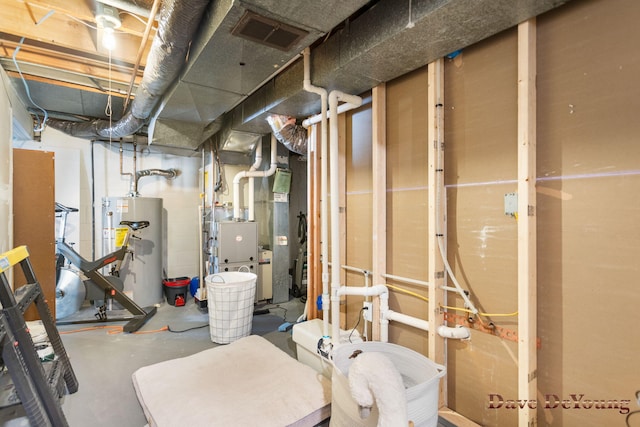 unfinished basement with water heater and visible vents