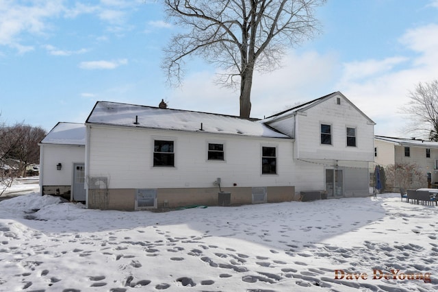 snow covered property featuring a garage