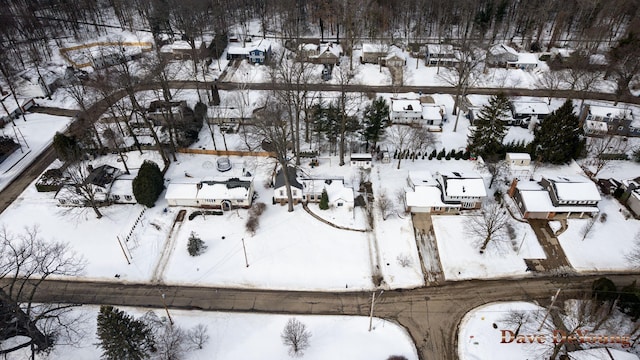 snowy aerial view with a residential view