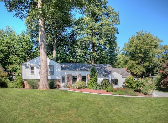 split level home with a chimney and a front yard