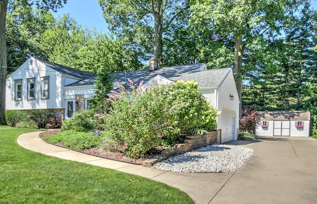 view of home's exterior with concrete driveway, an outdoor structure, a chimney, and an attached garage