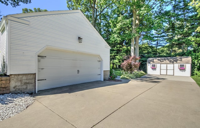 detached garage featuring a shed