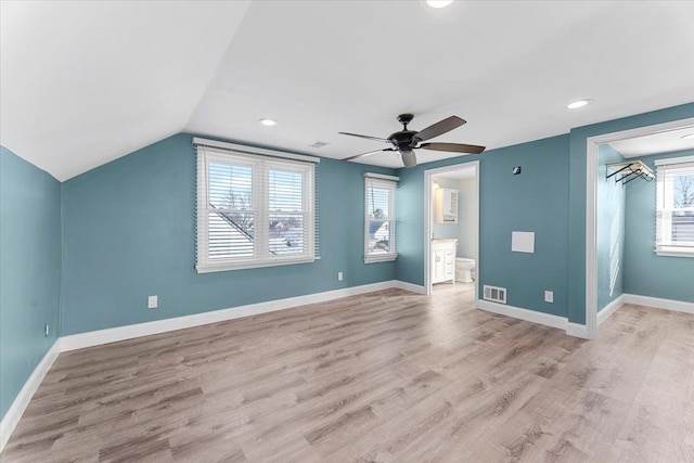 interior space with lofted ceiling, light wood finished floors, and baseboards