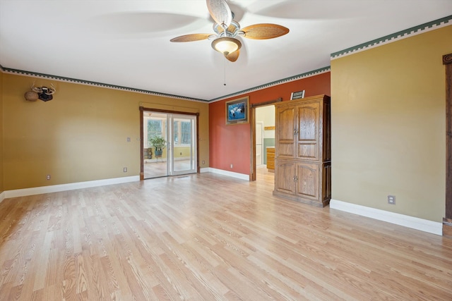 spare room featuring light wood-style flooring, baseboards, and a ceiling fan